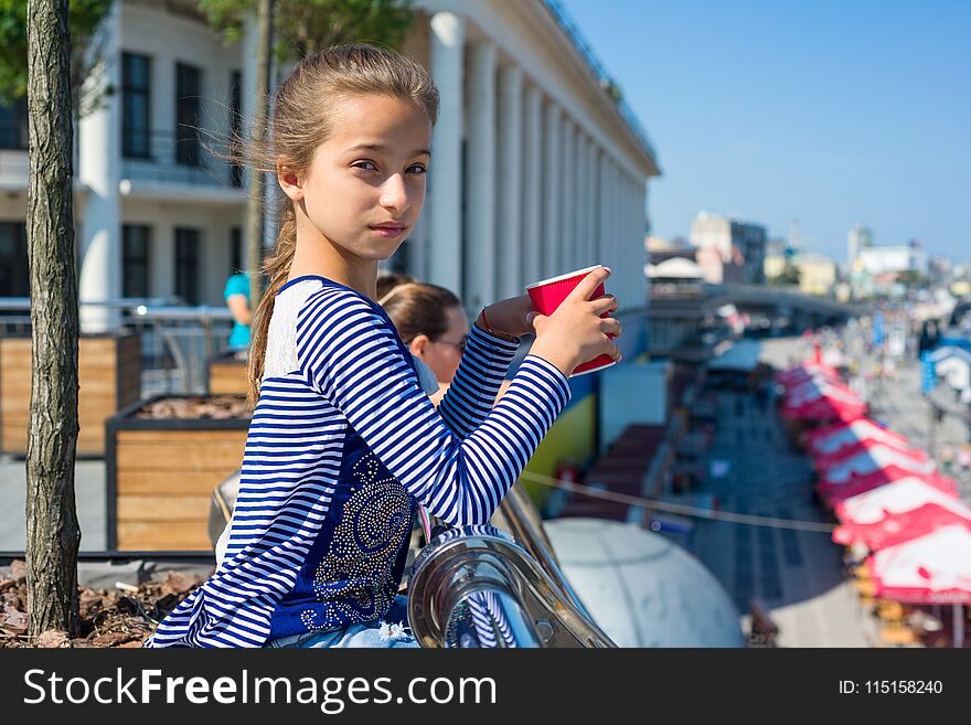 Portrait of a cool girl 10 years old, City Embankment, European city