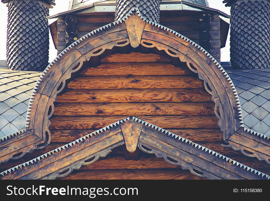 Fragment of a log house with elements of Russian architecture, wooden carvings.