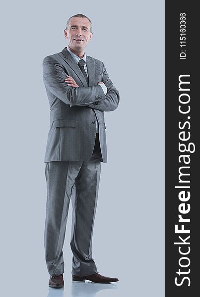 Mature Business Man Arms Folded On Gray.