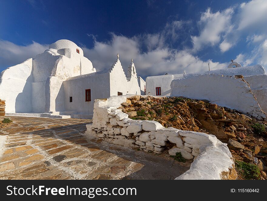 Snow-white Orthodox Church of the Holy Virgin against the blue sea. Greece. Mykonos. Chora. Snow-white Orthodox Church of the Holy Virgin against the blue sea. Greece. Mykonos. Chora.