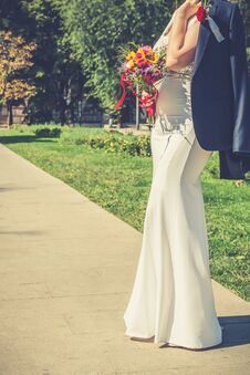 Elegant Bride Holding Groom`s Jacket Over Her Shoulder Stock Image Elegant Bride Holding Groom`s Jacket Over Her Shoulder Stock Image