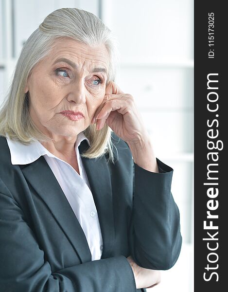 Portrait of upset mature woman in office