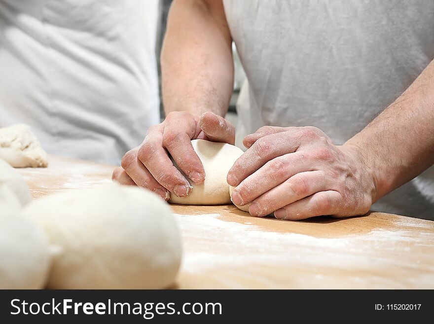 Baker, pastry chef prepares the dough for baked goods. Baker, pastry chef prepares the dough for baked goods