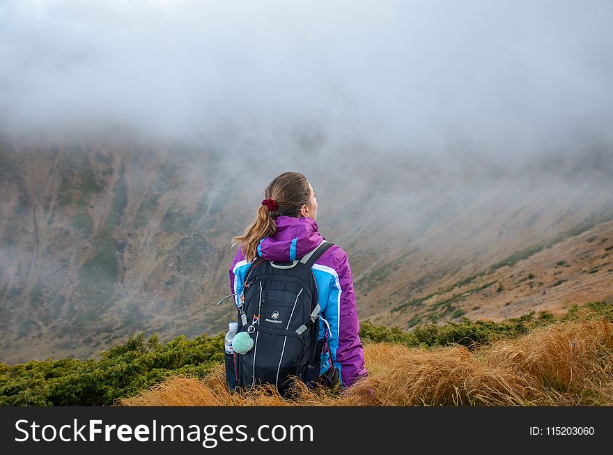 Woman Standing on Mountain Wearing Black Backpack
