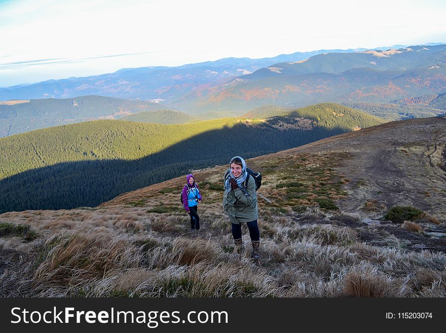 Two Women Trekking Up a Mountain