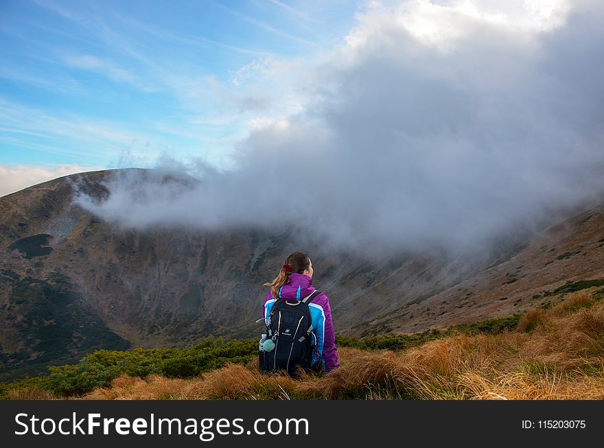 Photography of Woman Wearing Jacket on Mountain Peak