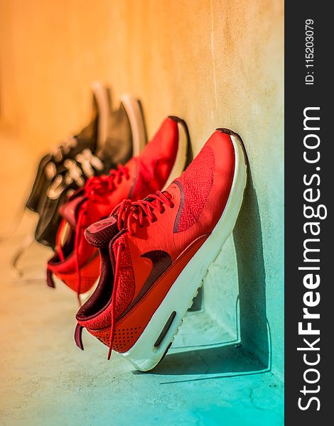Focus Photography of Pair of Red Nike Running Shoes