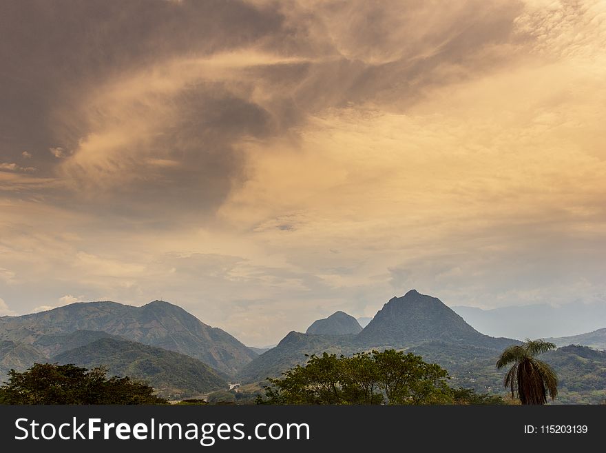 Scenic View of Mountain Under Cloudy Sky
