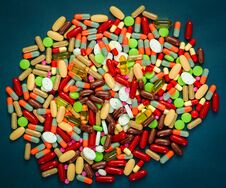 Pile Of Colorful Tablets And Capsules Pills On Blue Background. Antibiotic Resistance And Drug Use With Reasonable Concept. Royalty Free Stock Images