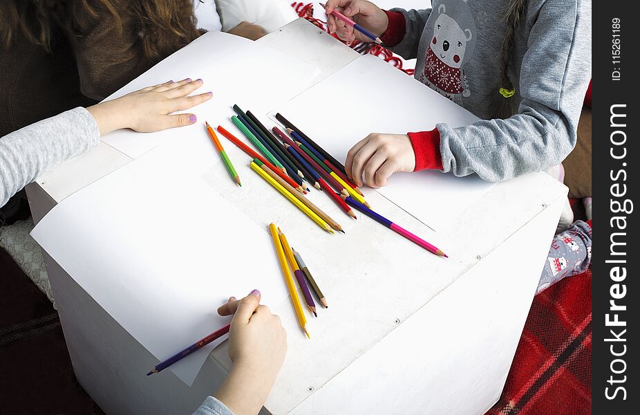 Children paint with colored pencils on white album sheets. Children paint with colored pencils on white album sheets