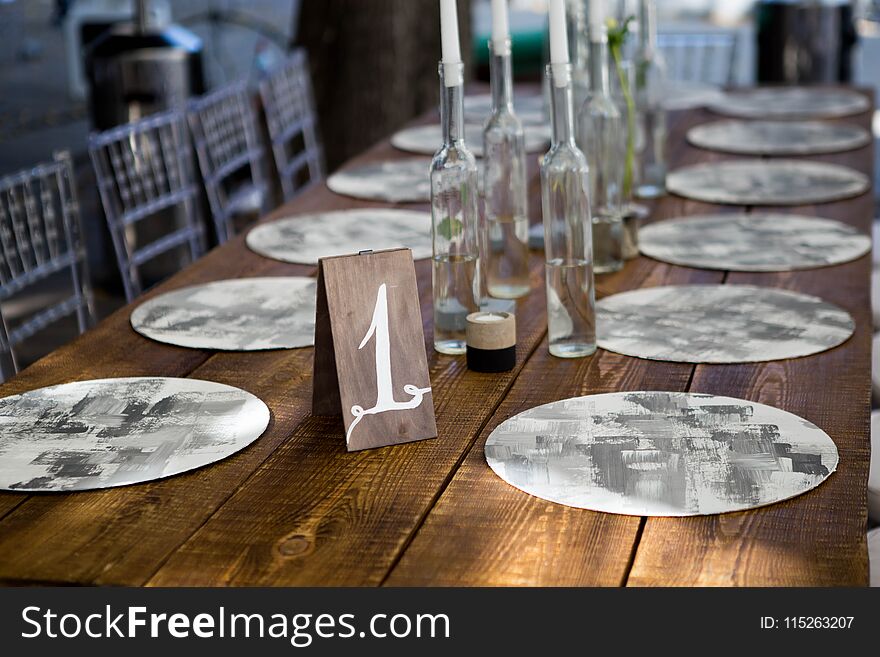 Table With Food And Flowers On The Wedding. Number 1 Written On White Card Stands Before The Bouquet In The Center Of Dinner Table