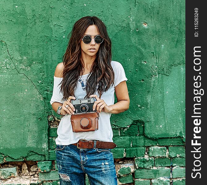 Stylish girl with vintage film camera.