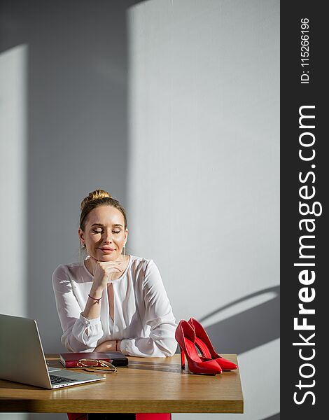 Meditative smiling businesswoman dreaming of future success at workplace, positive thinking