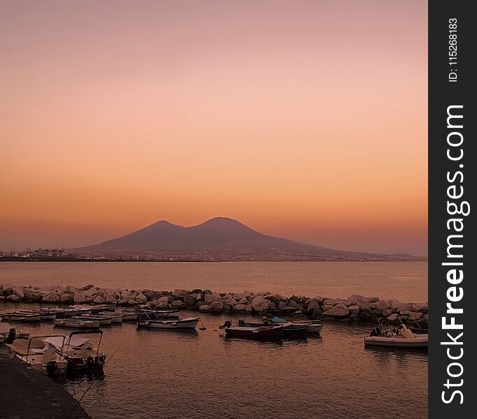 Vesuvius at sunset from harbour, Naples, Italy
