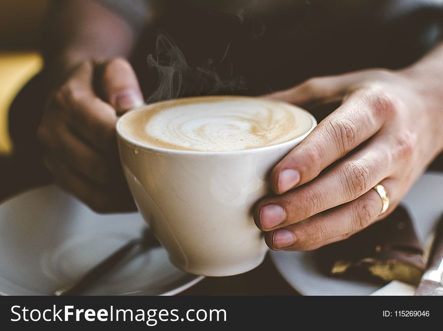 Close-Up Photo Of Person Holding Cup Of Coffee