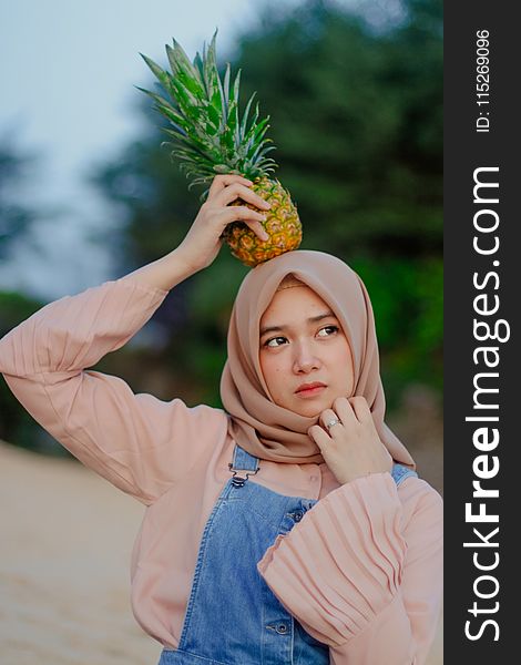 Woman Holding Pineapple on Her Head