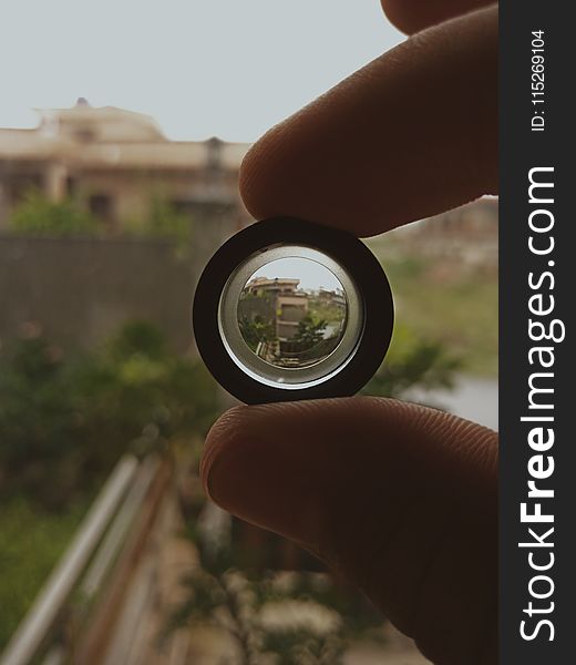 Person Holding Black Lens