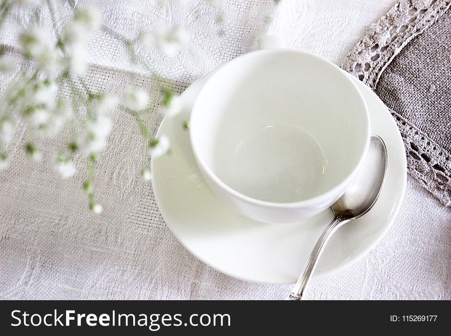 White Ceramic Tea Cup With Saucer and Spoon