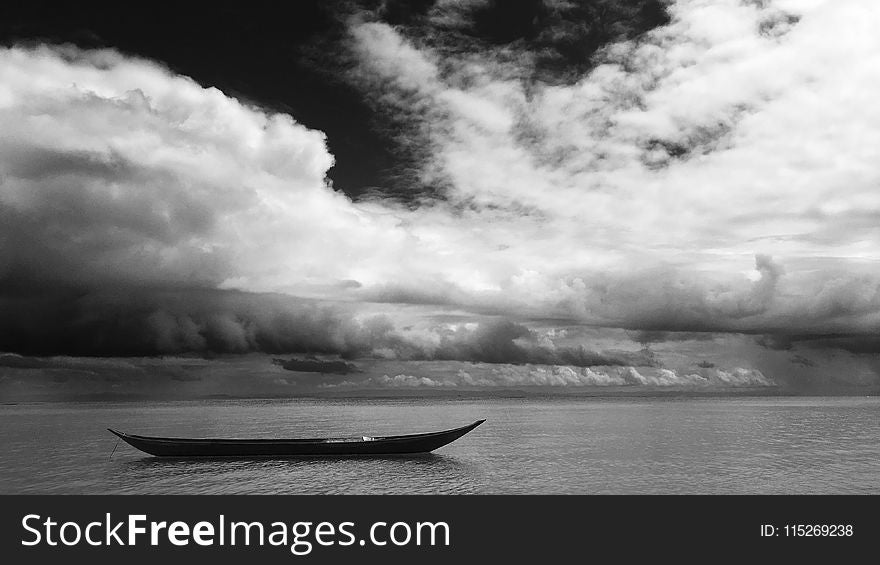 Grayscale Photo of Black Boat