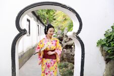 Traditional Asian Japanese Beautiful Woman Wears Kimono In A Spring Garden Park Stand By Bamboo Enjoy Free Time Fan Royalty Free Stock Photography