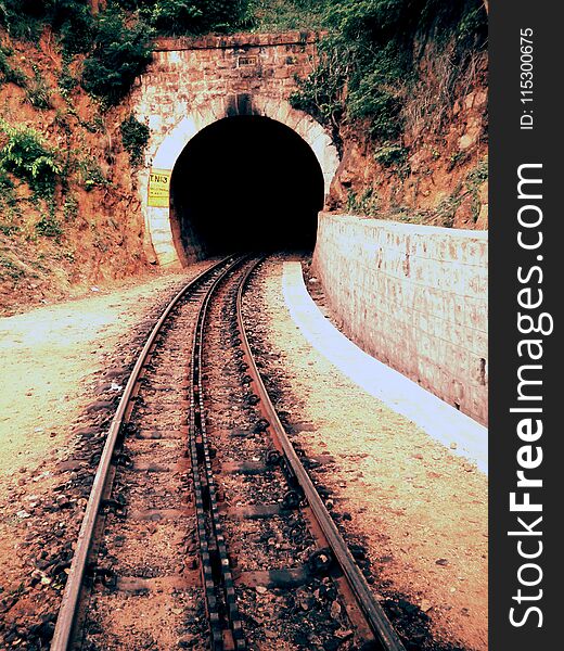 Train track leading to tunnel