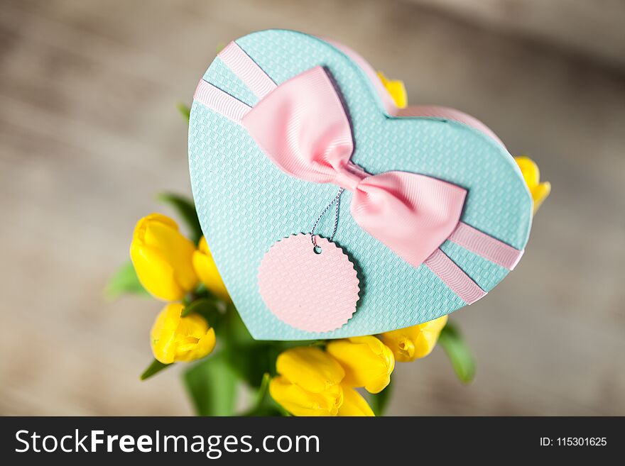 Yellow tulips on wooden background