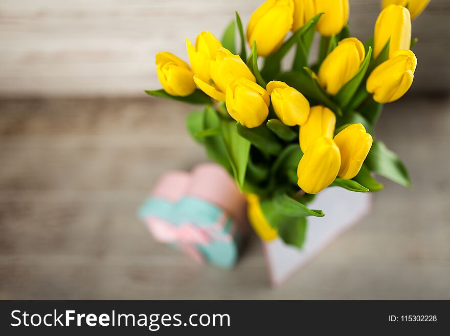 Yellow Tulips On Wooden Background