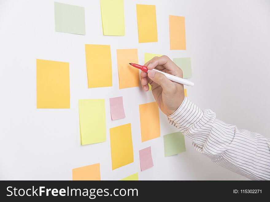 Hand writeing sticky note or post is on white bulletin billboard