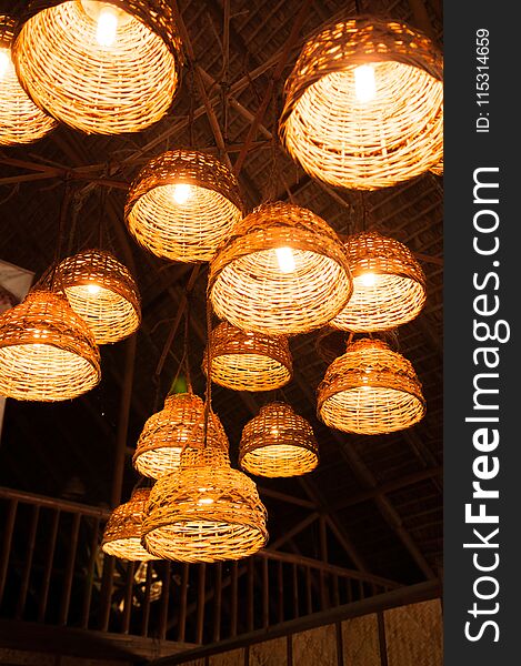 Illuminated rustic simple desing woven bamboo lamps hang from ceiling. Illuminated rustic simple desing woven bamboo lamps hang from ceiling