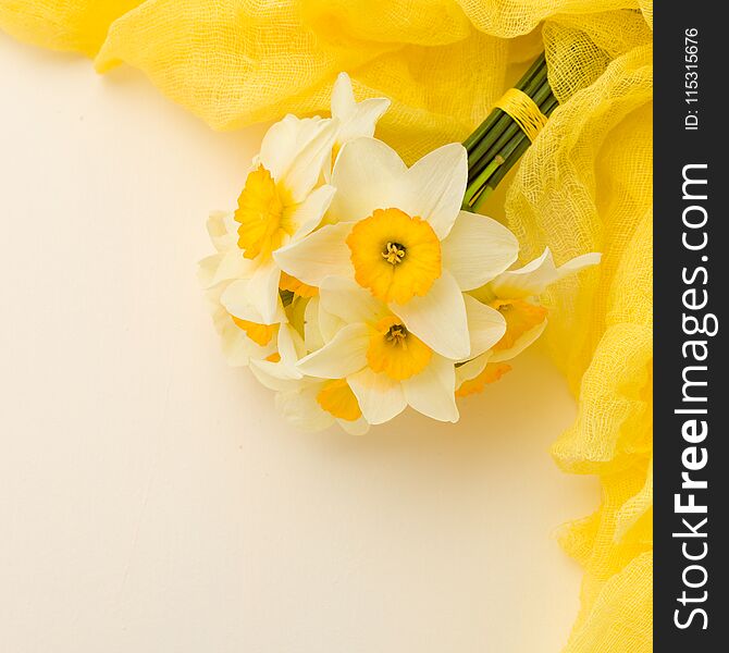 White Daffodil Bouquet With Yellow Textile Decoration On Pastel Background With Copy Space.