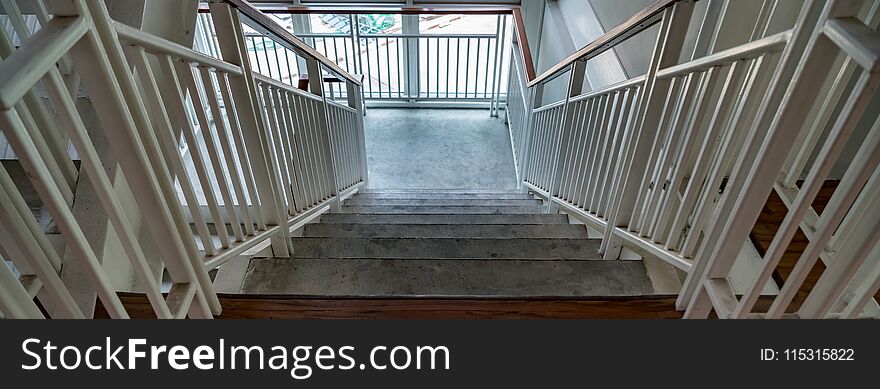 White iron railing on wooden stair