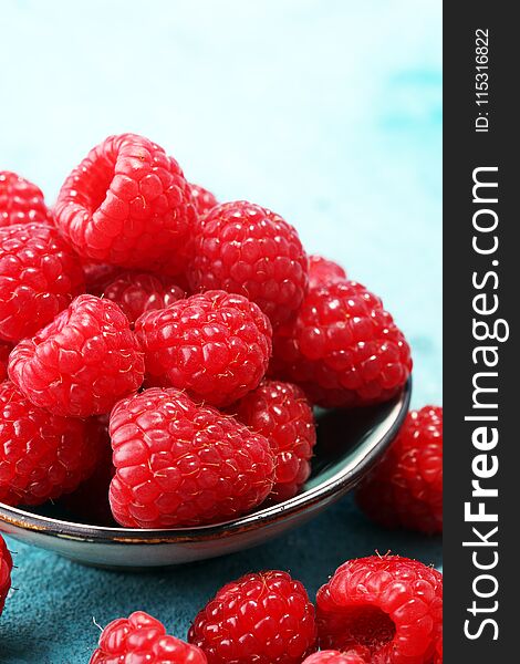 raspberries. Raspberry on blue background. Summer and healthy food concept