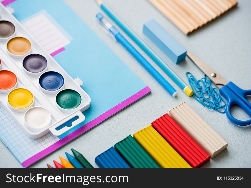 Good preparation for school subjects. School accessories of color plasticine, multi-colored pencils, paper clip scissors