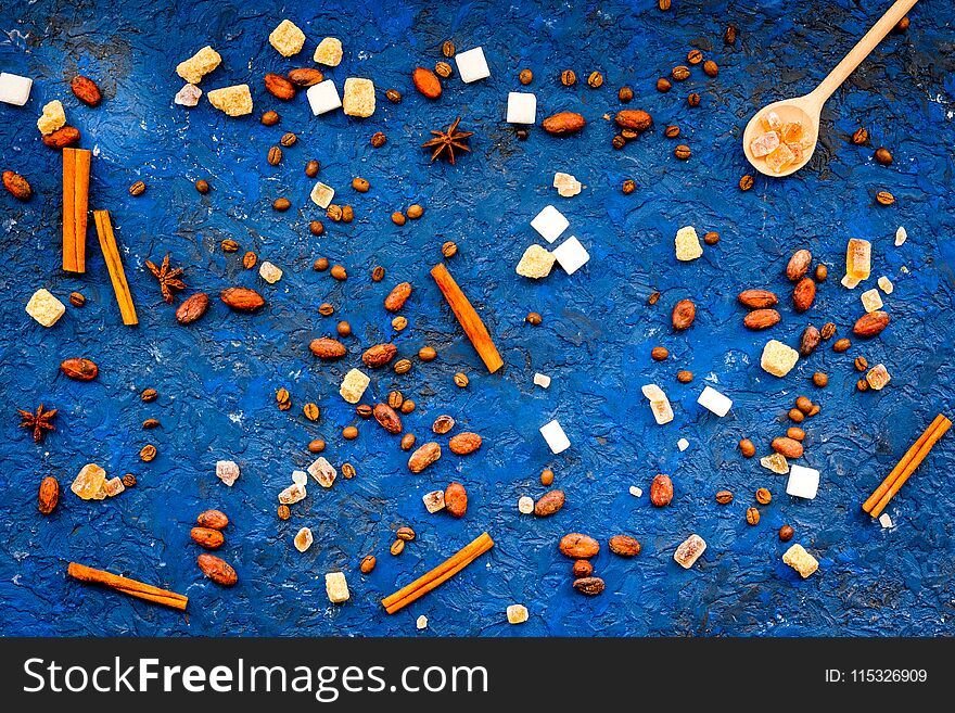 Seasoning for sweets and desserts background. Sugar, badian, cinnamon on blue table top view.