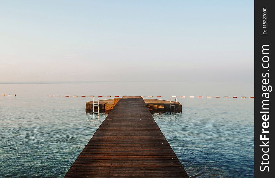 A wooden pier in blue Adriatic sea in Budva, Montenegro