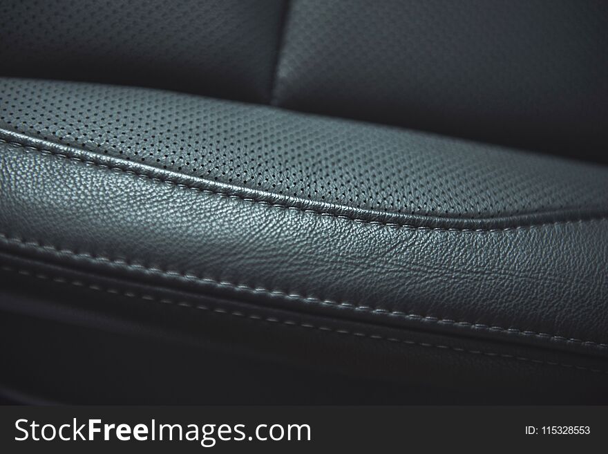 Leather background. Part of car seat. Macro photo