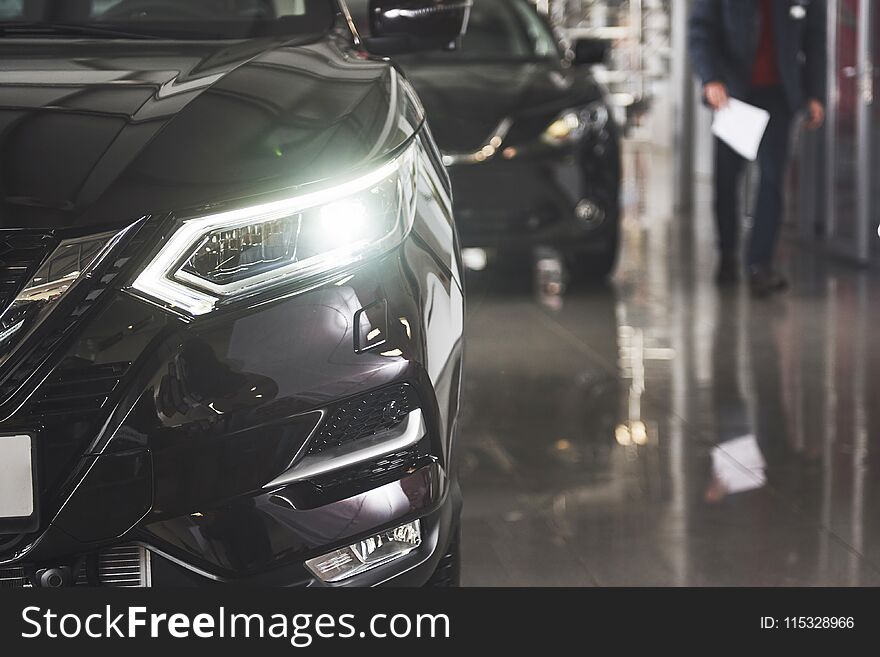 The Headlights And The Hood Of A Black Luxury Car