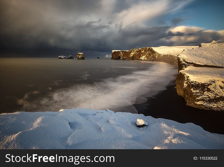 Dyrholaey cape over black sand beach