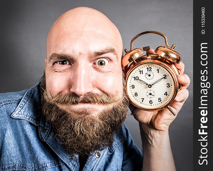 An expressive man with alarm clock