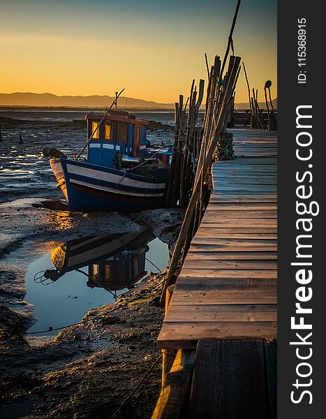 Sunset view of Carrasqueira palaffitic port with old boats in Portugal. Sunset view of Carrasqueira palaffitic port with old boats in Portugal