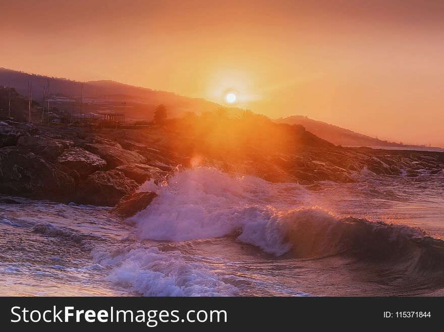 The sunrise on the beach. The sky to the sunrise. The first rays of the sun are bathed in the waves