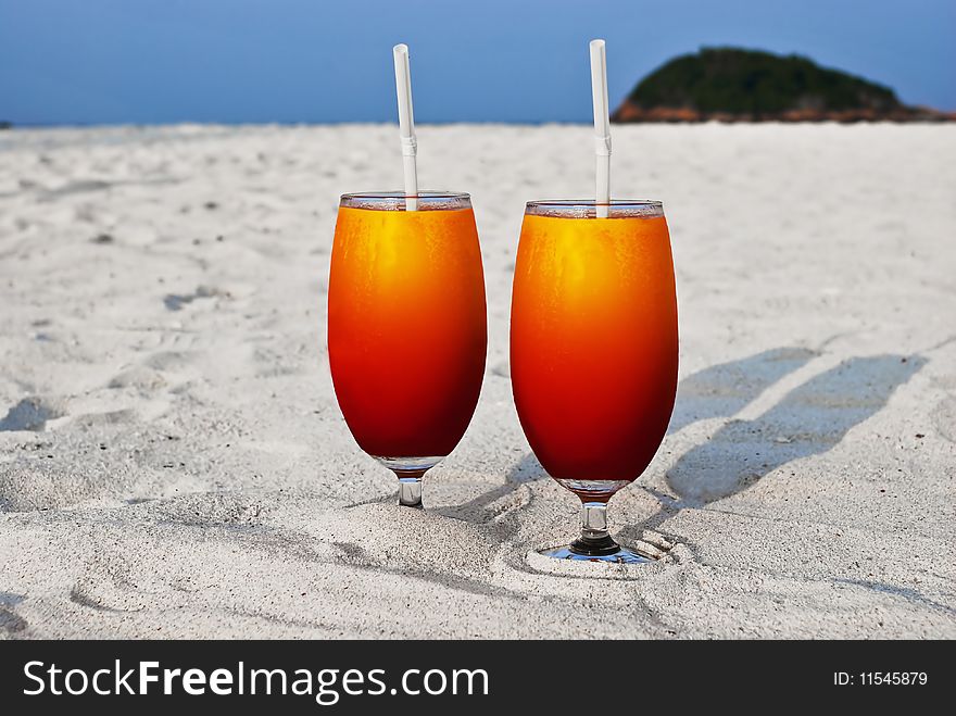 Two mix fruit juice with a straw on sandy beach at Maldive. Two mix fruit juice with a straw on sandy beach at Maldive