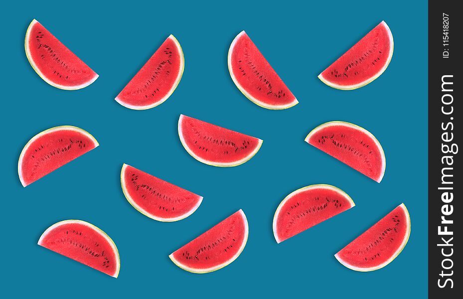 Colorful fruit pattern of fresh watermelon slices on blue background. From top view. Colorful fruit pattern of fresh watermelon slices on blue background. From top view