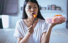 Young Asian Woman Eating Fresh Fruits Papaya Slices,Concept Healthy Food Royalty Free Stock Photos