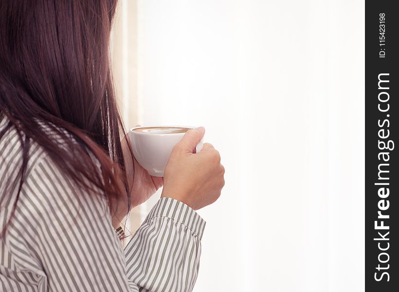 Photo of Woman Holding Cup of Coffee