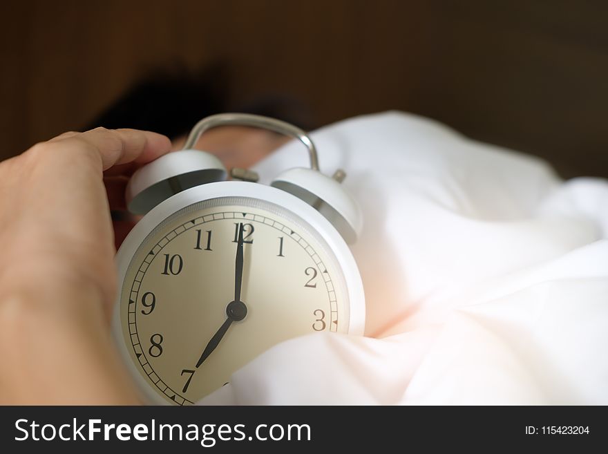 Photo of Person Holding Alarm Clock