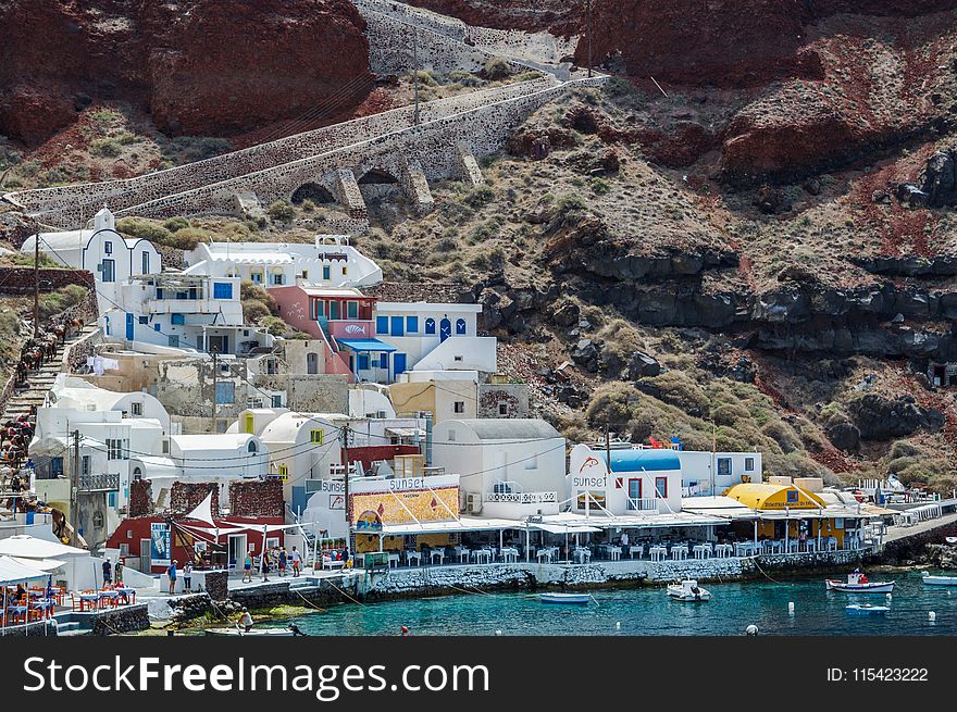White and Blue Houses Beside Body of Water
