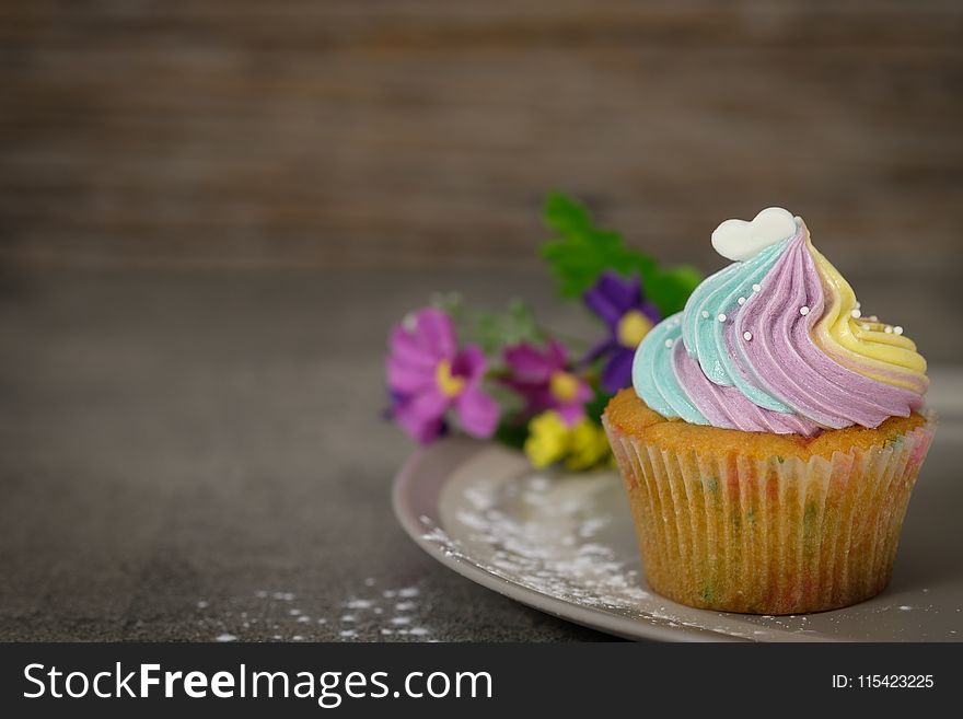 Close Up Photography Of Cupcake On Gray Ceramic Plate