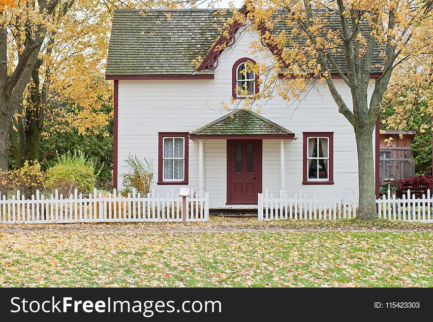 White And Red Wooden House With Fence