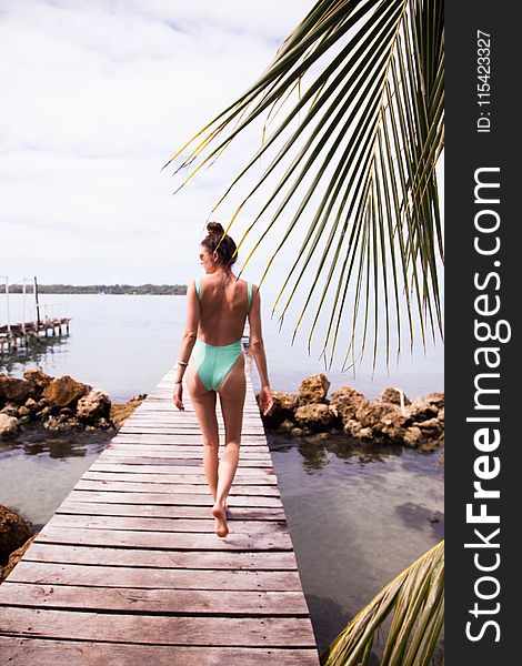 Photography Of A Woman Walking On The Dock